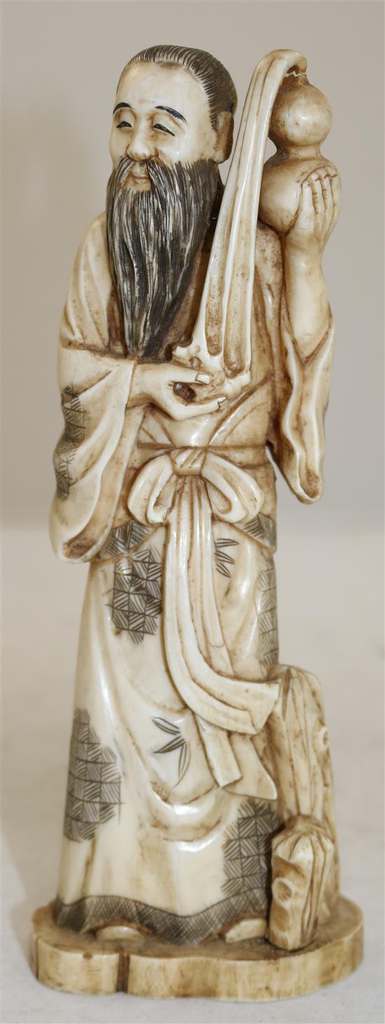 A Japanese walrus ivory figure of a man pouring water from a gourd, early 20th century, height 21cm